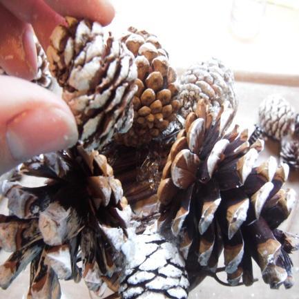 Use the medium but slightly larger size pine cones to fill in between the larger pine cones.