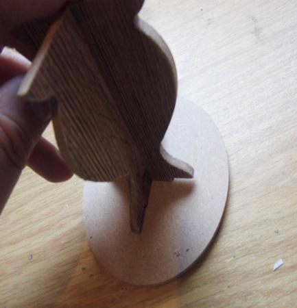 Step 16. Now place the legs into the base of the MDF circle top piece.