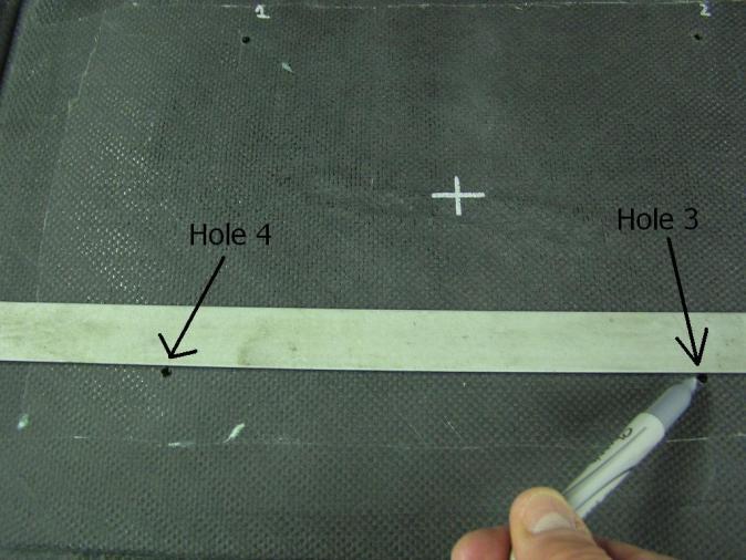 6) On the base draw a line from hole 1 to hole 2 and from hole 3 to hole 4. These lines will be used to help locate the oval template (Photo 9).