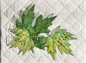 Arrange the leaf appliqué pieces from back to front on the nonstick pressing sheet. Fuse. Gently peel the unit off the sheet and set aside.