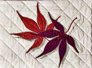 To do this, start at the bottom center of the leaf and stitch to the top and back down, adding side veins as you go. Place a piece of stabilizer under the leaves before stitching the stems.