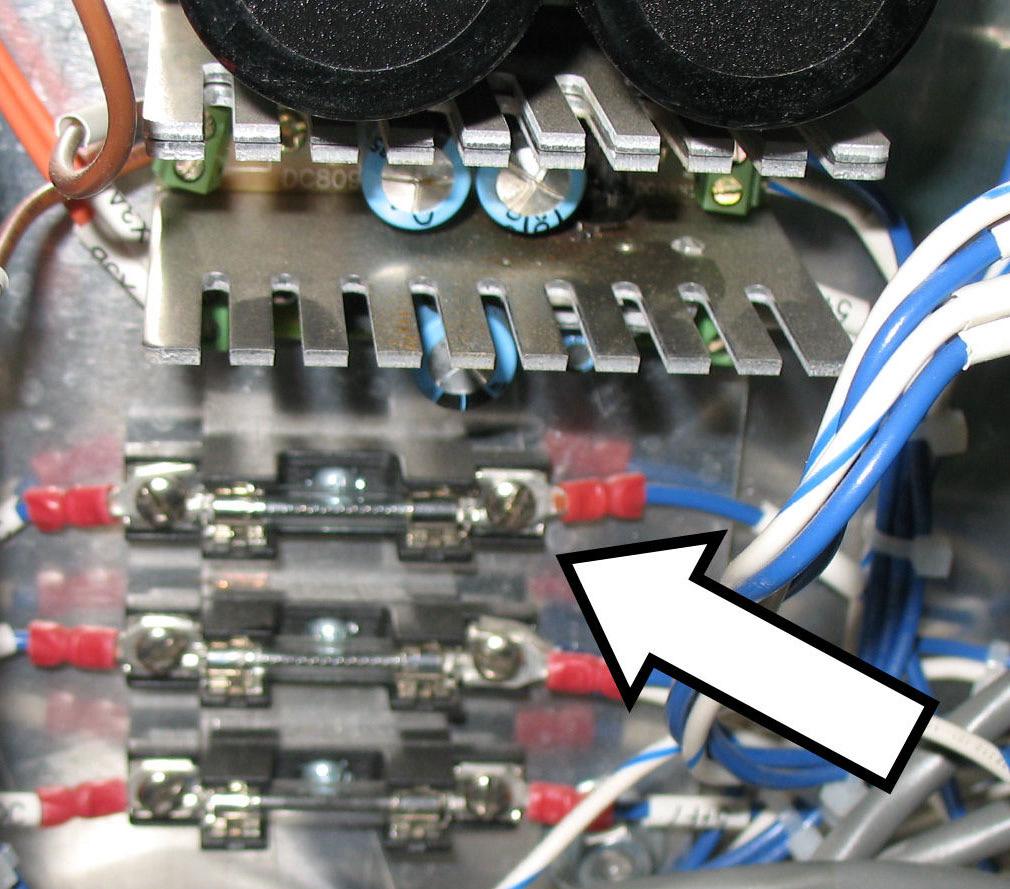 Locate the 63v fuse on the right side of the board, marked by a white label on the incoming wire.