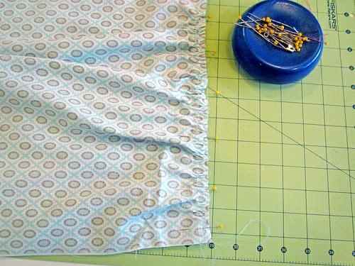 Slide the gathers along the thread so they are evenly distributed. Pin in place, making sure you pin through all layers. 12.