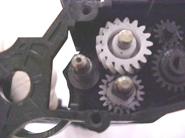 Use needle nose pliers to pull the gear off the developer roller (Fig.