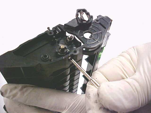 Fig. 15 15. Use a small flat-head screwdriver to release the locking tab on the bottom of the developer roller plate.