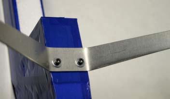Slide the bolt through the landing gear from the outside, and retain it in place by firmly screwing on a second locking