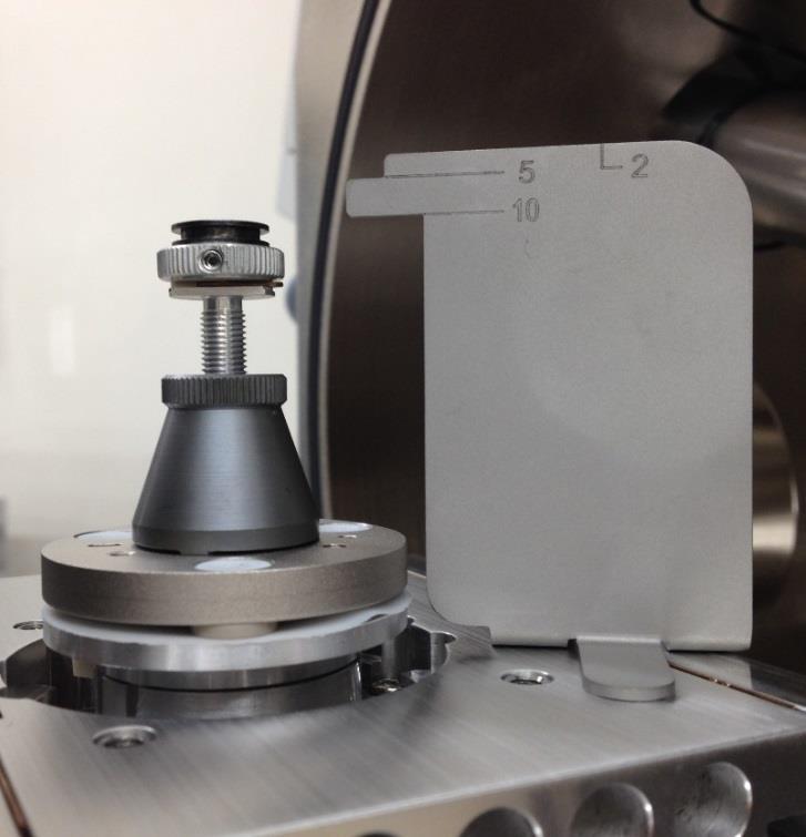 It is adjustable by turning the top of screw 2 after loosen a base of sample holder 1, or by using Z