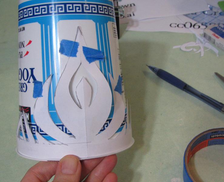 Use a few tiny pieces of masking tape to secure pattern to the container. 3. Trace around the pattern with marker and remove pattern from container.