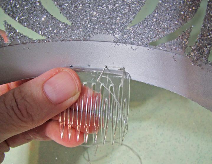 14. With a hand sewing needle and thread, sew the comb to the