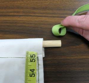 Use a small hand saw to cut the dowel to 16 1/2 inches. Insert the dowel into the pocket.