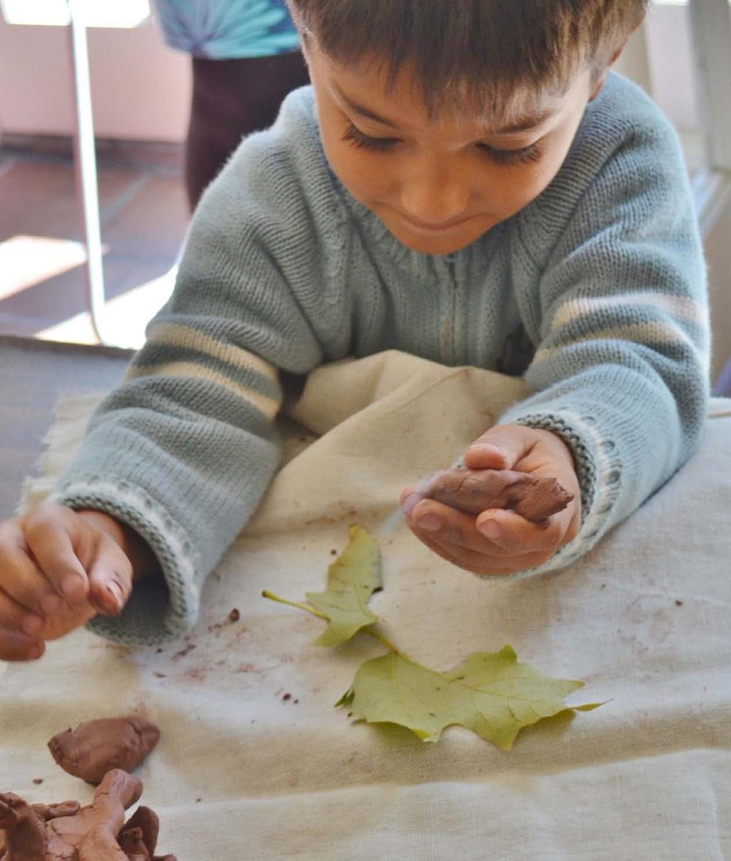 Toddler working on a leaf print during the