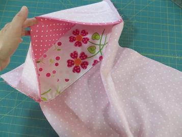 Fold the extra fabric, the bit that is sticking out at the top of pillowcase, down and over the front of the
