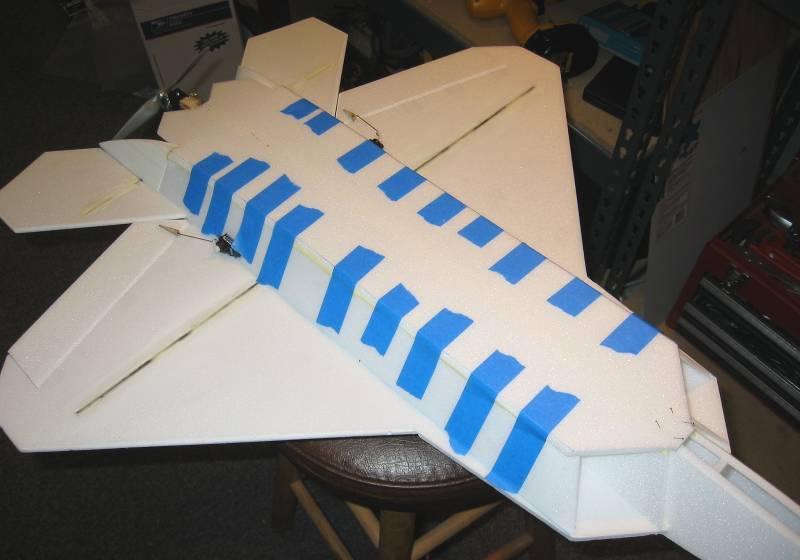 Next use a long sanding bar to sand across the bottom edges of the fuselage to make it perfectly flat and straight (middle picture).