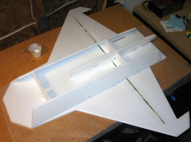 Place wax paper and some heavy books on top of the wing to hold it perfectly flat as the glue cures.