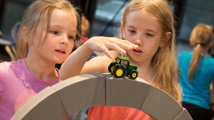 John Deere Pavilion For people who love: seeing, doing, exploring. Get a hands-on experience. Touch the machines. Climb on board. Picture yourself driving.