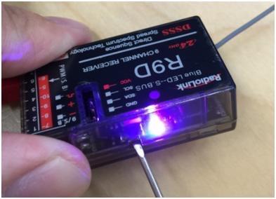 Press the tiny black button on the side of the receiver twice with small screwdrivers to make LED indicator turns PURPLE to enter S.Bus mode. 2.