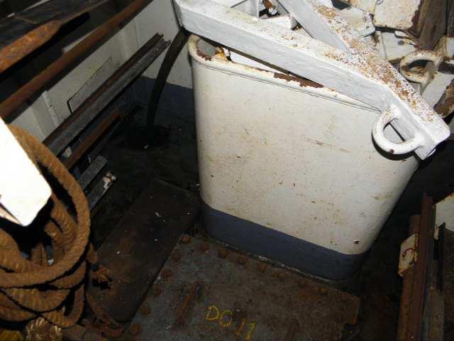 height 100 mm just forward of a man hole across the width of the hold,