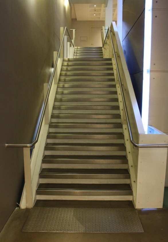 There is a hand rail on the staircase and landings in the stairs.