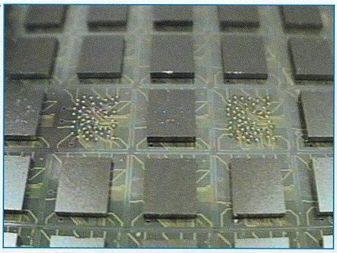 Figure 5. Dynamic random access memory (DRAM) chips flip-chip assembled on good application-specific integrated circuit (ASIC) sites with re-route interconnection visible on the ASIC wafer. Figure 4.