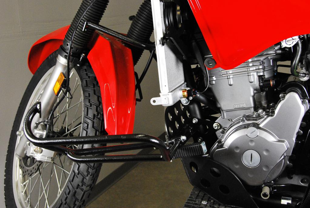 Using an M6 bolt and nut, loosely attach to the Nerf bar. Install the left crossover (with the nuts facing the rear of the bike) into the area behind the frame downtube where the aluminum blocks are.