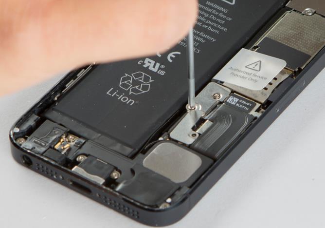Remove the metal battery shield held down by two