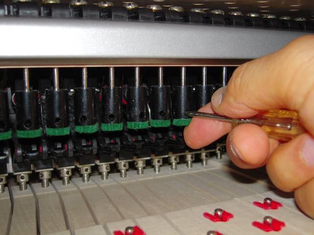 Press each key down slowly with one hand while adjusting the letoff dowel