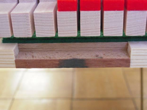 To move the action forward glue a shim (thin wood veneer) onto the hard wood block at the