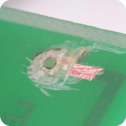 2 REMOVE SOLDER RESIST Scrape a little of the solder resist off with a knife, sharp screwdriver, or fine sandpaper.