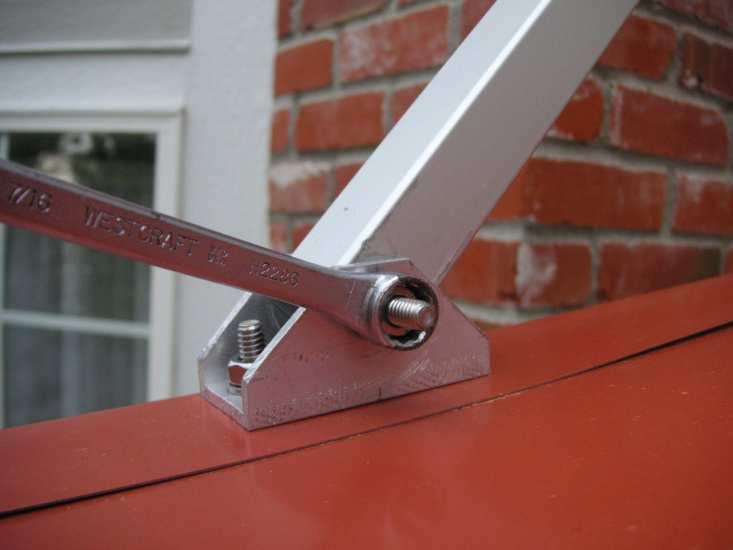 Large awnings with middle rafters only: Mark holes for middle brace brackets and secure middle brace brackets to the wall in the same manner.