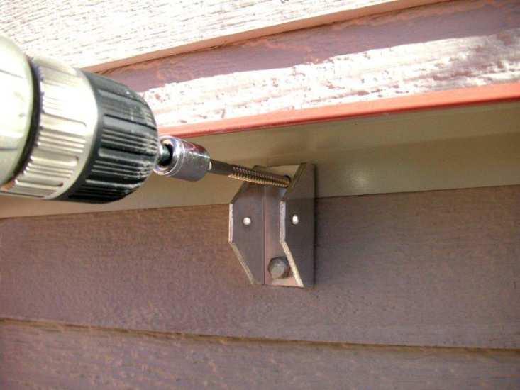 Do not tighten completely. Wall bracket STEP 2. Insert the top flashing behind the wall brackets and lower it by approximately 3/4" below the top of the brackets.