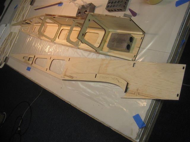 *Prepare the fuselage sides for assembly by gluing in place the Reinforcement Saddle to the fuselage sides.