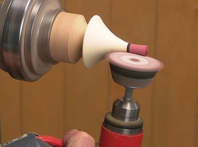 Insert the dowel into a drill chuck, which is seated firmly into the headstock.
