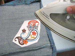 Sew a 1/4 inch seam along the inner edges of the folded jean fabric.