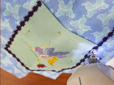 Add 1/2" wide decorative trim to the outer edges of the embroidered section.