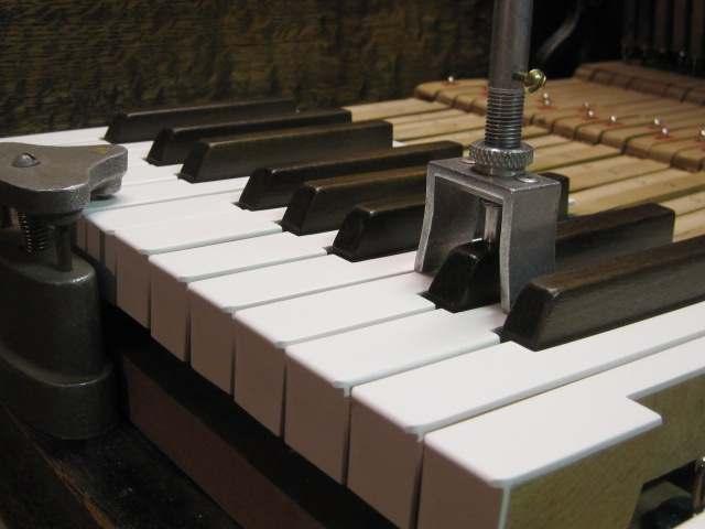 Where would the work be done, if the decision was made to replace the keytops of our piano? This type of job is done in the shop.