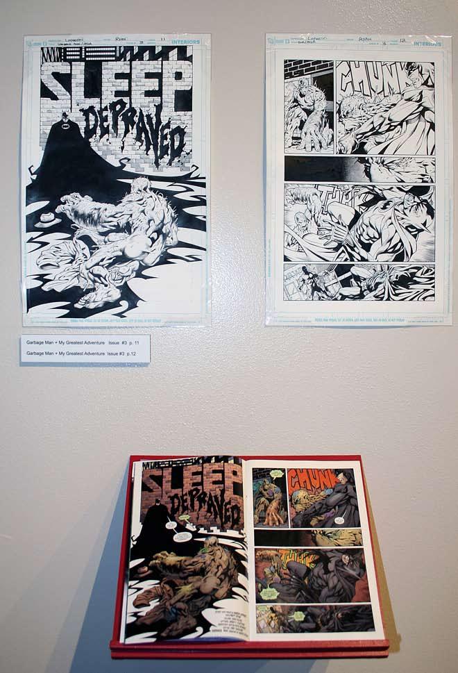 Installation view showing original pages with the comic book they appeared in.