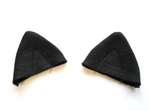 Once your animal accessories are ready to go, it's time to place for them on your hat for sewing! For the kitty, your ear placement will look like this.