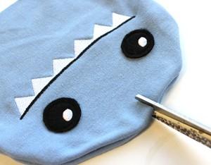 With your hat right side out, snip an opening in the middle top of your sharky hat.