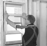 With index fingers, slide tilt latches (on top of bottom sash) (FIGURE 1) towards center of window