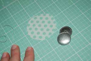 8. Take your co-ordinating mini charm square, and trim to fit your fabric button pieces. Cover your button as per the instructions given on the pack. 9.