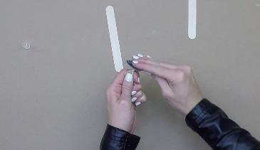two popsicle sticks so that they