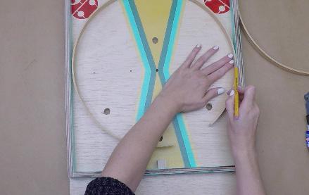 28. Bend the embroidery hoop so that it touches the top,