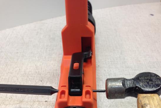 41. Insert 3/32 Drift Pin Punch into orange housing and through the hole in the advance lever. Insert the black round plastic spacer. Push pin punch through center hole.