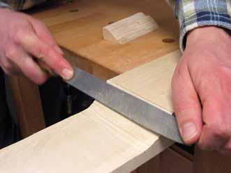 Smoothing the cut with a rasp.