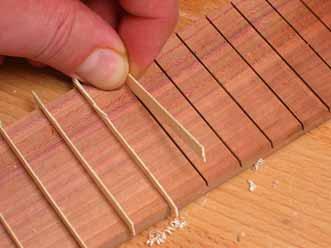 Filling the fret slots I filled the fret slots with 0.024 (0.6mm)-thick veneer strips.