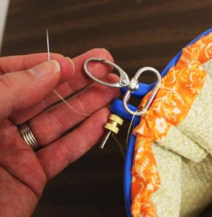 Adjust the fabric around the top edge and fully tighten the hand screw.