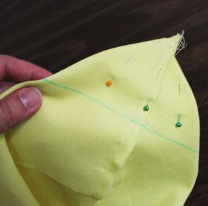 Bring the bottom edge up to meet the side edges (align the seams on one side and fold the opposite side to match).