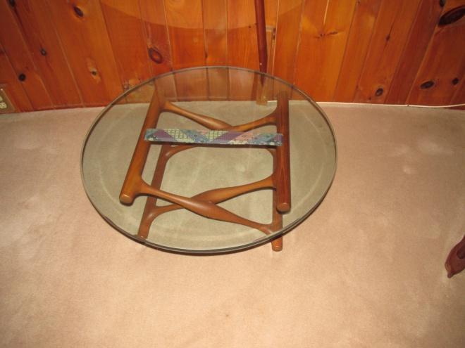 Lot # 25 Glass and teak tables Teak legs with glass top Quantity 2 Diameter: Details and Pictures STILL TO COME Light blue Teak sofa