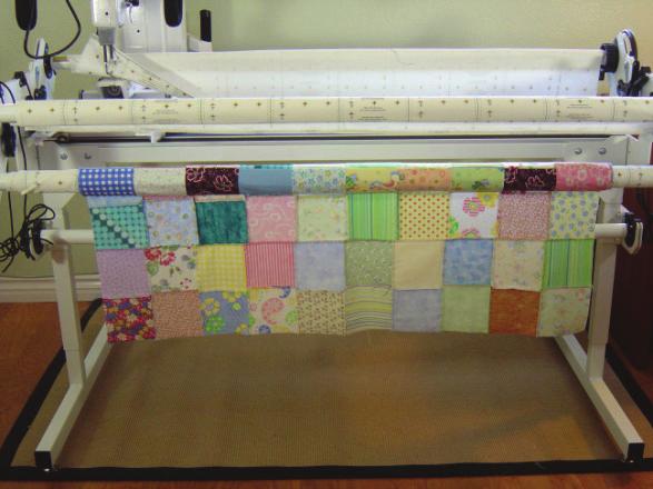 5. Roll the quilt top onto the quilt top a) Do not pull and tug on the top as you are rolling it b) Smooth it, if needed, to roll it evenly 1-