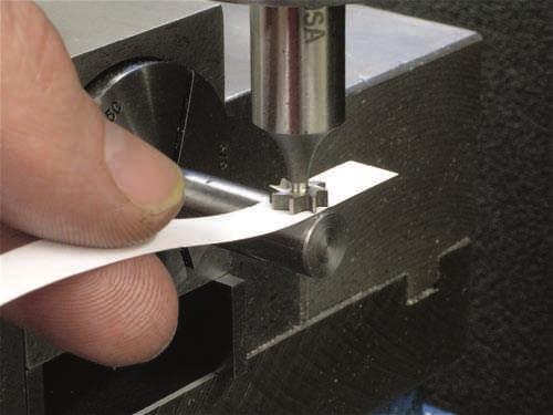 Use a liberal amount of cutting fluid to flush the chips out of the slot when machining T-slots or dovetails. Figure 6.3.80 shows a T-slot and a dovetail being machined.